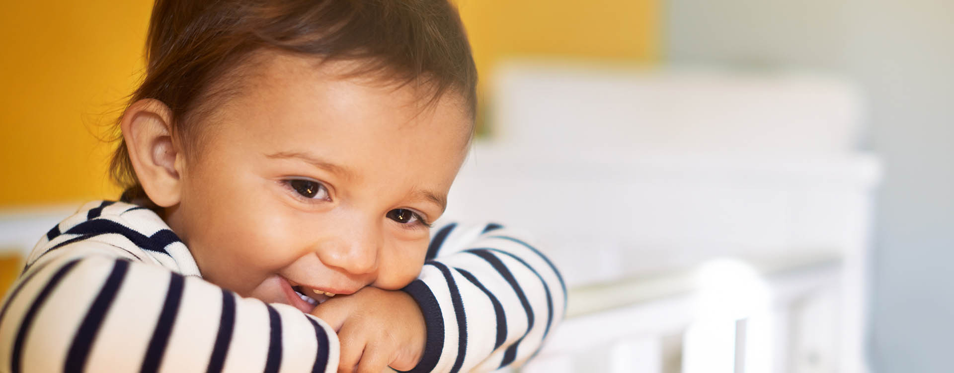 Child smiles in crib